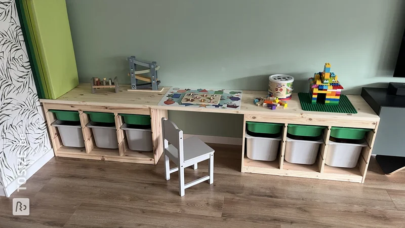A beautiful children's play table and storage space with a custom pine carpentry panel, by Britt