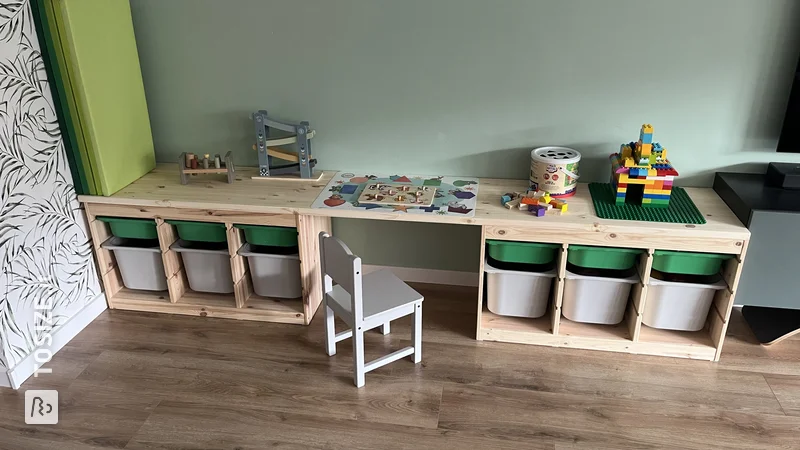 A beautiful children's play table and storage space with a custom pine carpentry panel, by Britt