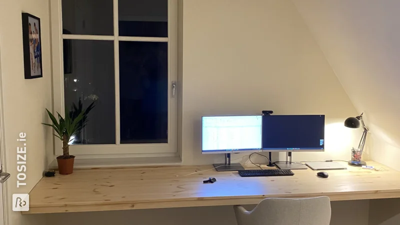 A homemade floating desk made of custom pine wood panel, by Bas