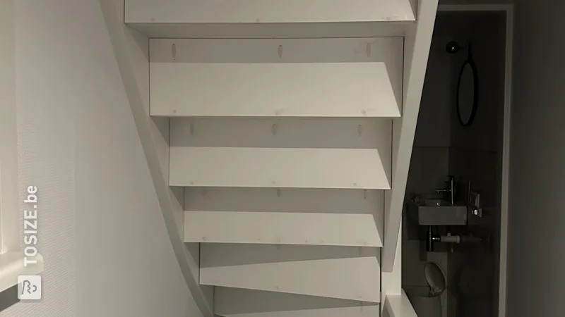 Close an open staircase yourself with custom plywood panels, by Iris