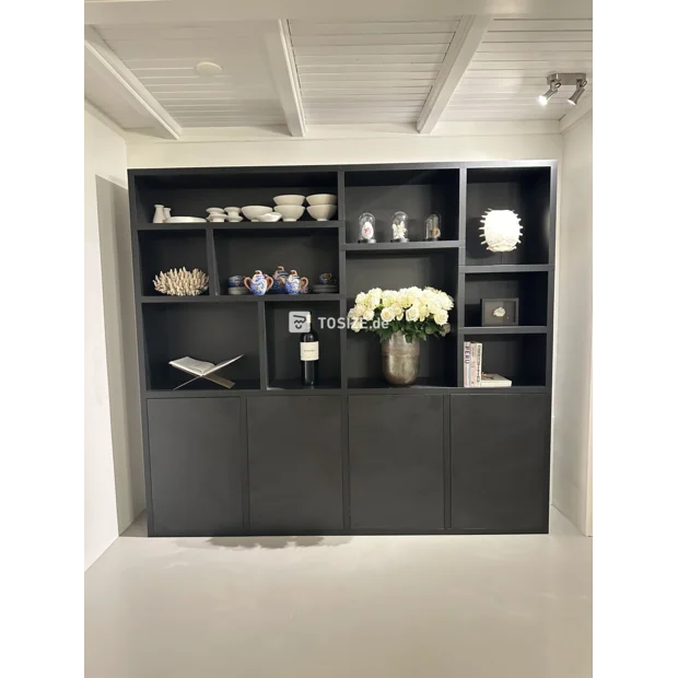 Black cupboard wall with open compartments and doors