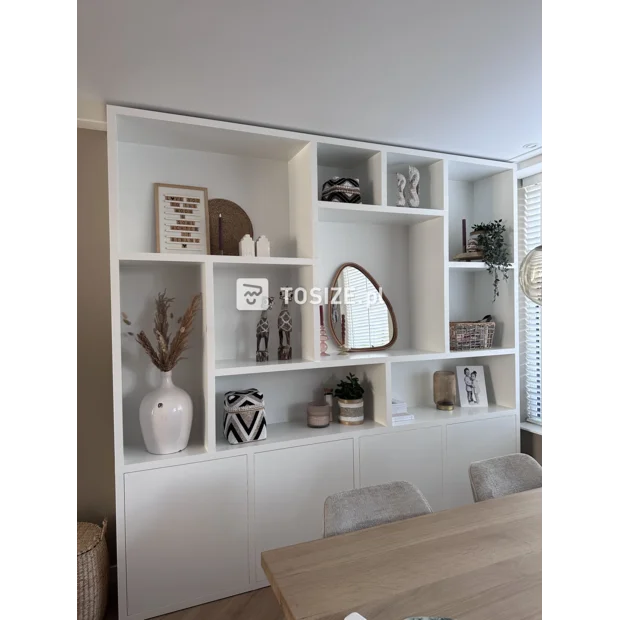 White cupboard wall with open compartments and doors