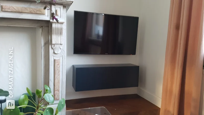 A floating TV cabinet of blue colored MDF, by Freya