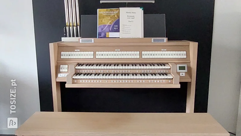 Dark custom-made black MDF wall covering behind the organ, by the Struik family