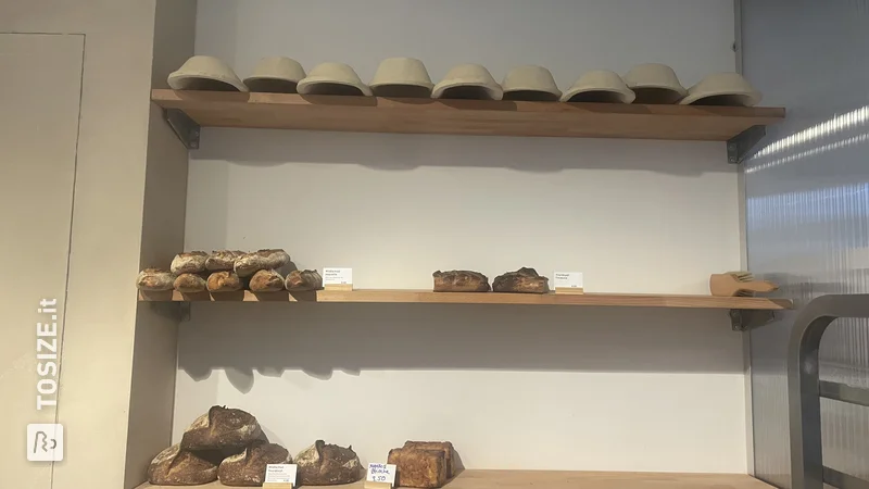 DIY shelves for breads in a bakery shop, by Loes