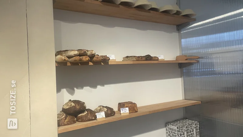 DIY shelves for breads in a bakery shop, by Loes