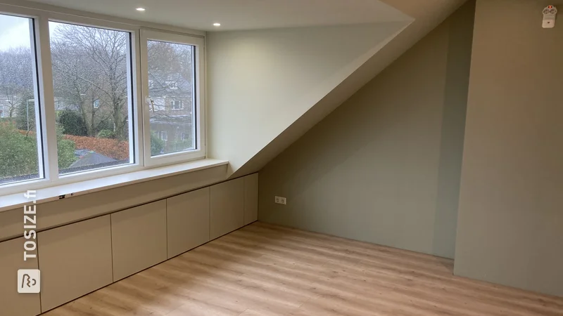 Custom storage space with doors under a sloping roof, by Mike