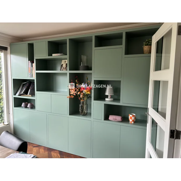 Green cupboard wall with doors and open compartments