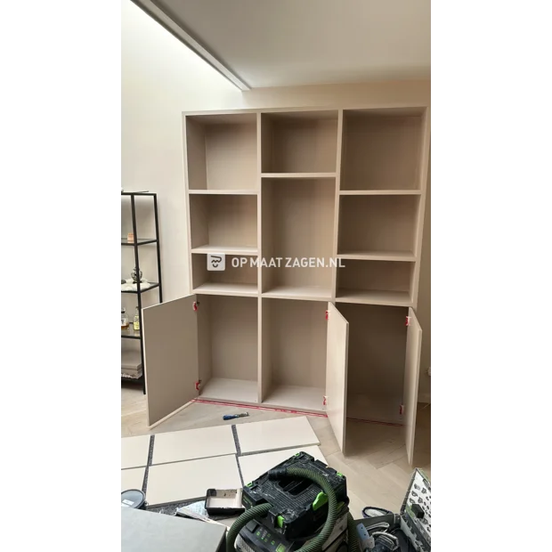 White cupboard wall with open compartments and doors