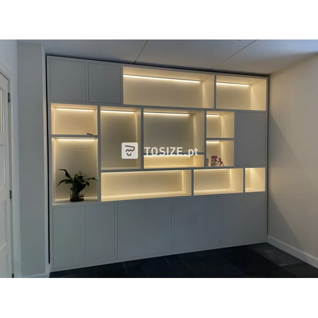 White cupboard wall with open compartments and doors