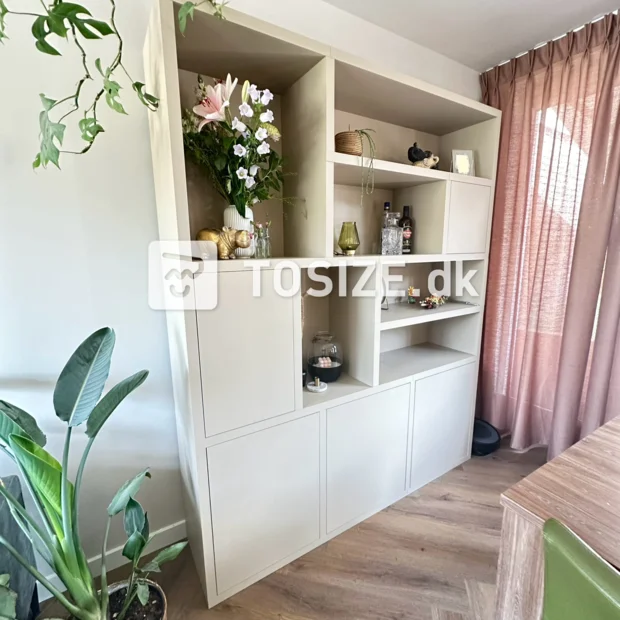 Beige cabinet with open compartments and doors