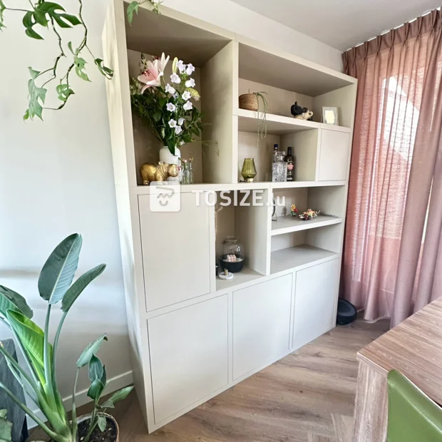 Beige cabinet with open compartments and doors