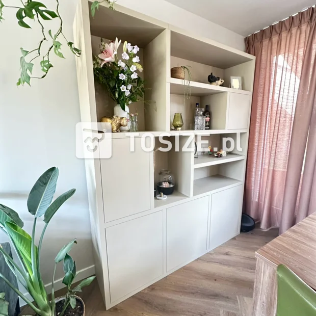 Beige cabinet with open compartments and doors