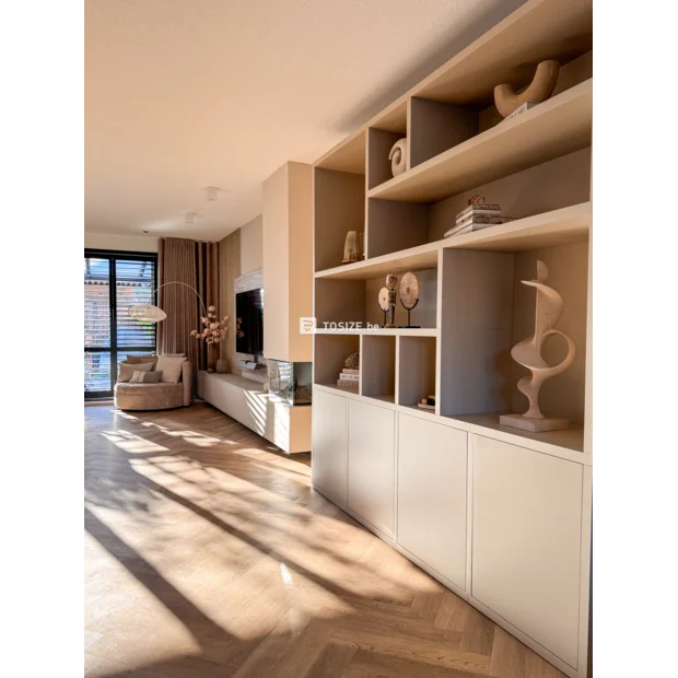 Beige cupboard wall with open compartments and doors