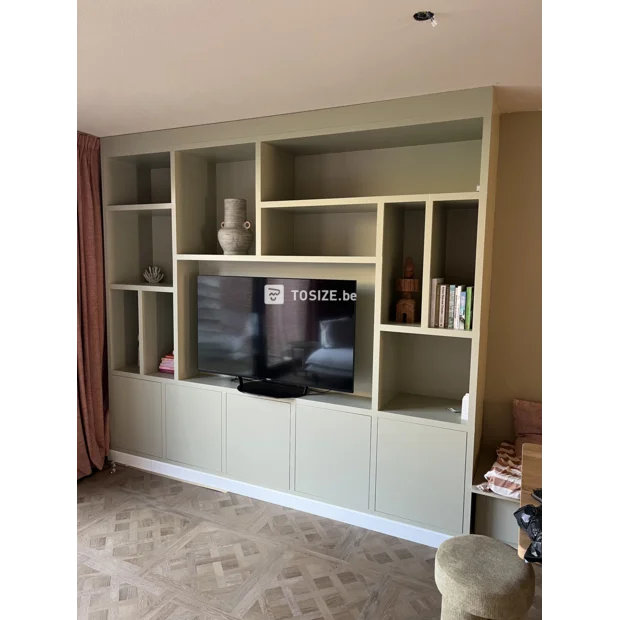 Green cupboard wall with open compartments and doors