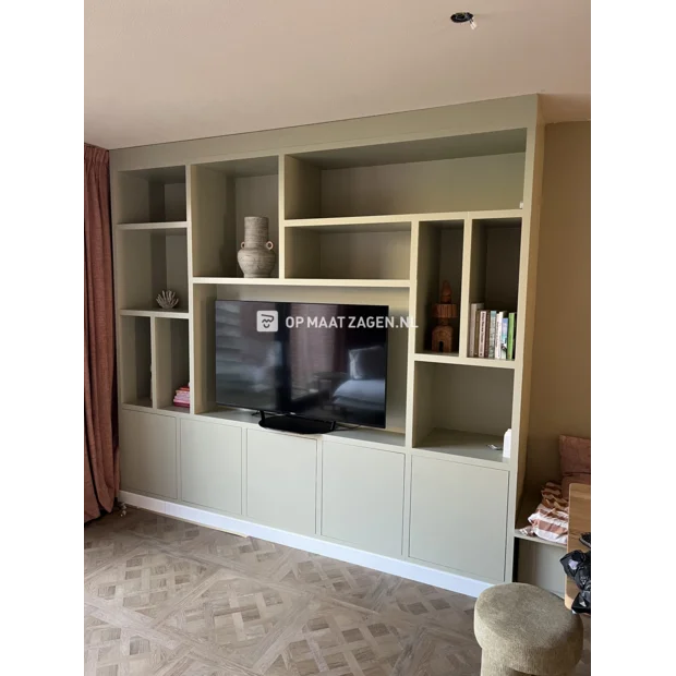 Green cupboard wall with open compartments and doors