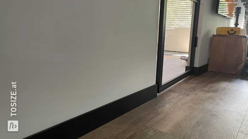 DIY black MDF skirting boards in the living room, by Mark