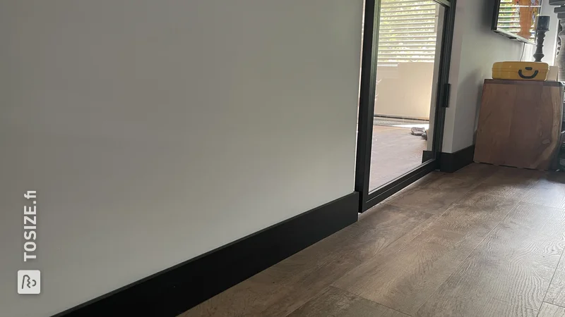 DIY black MDF skirting boards in the living room, by Mark