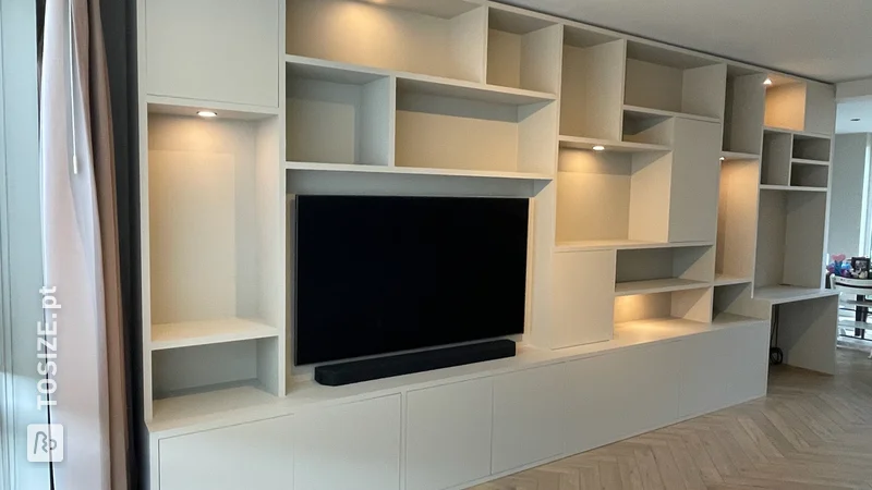 Custom wall-filling media cabinet with desk, by Hugo
