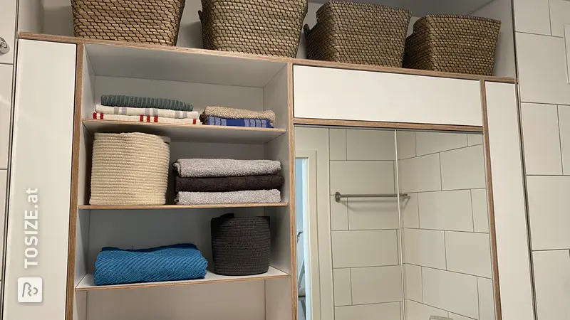 Stylish white bathroom cabinet that also functions as a mirror cabinet, by Zeyna