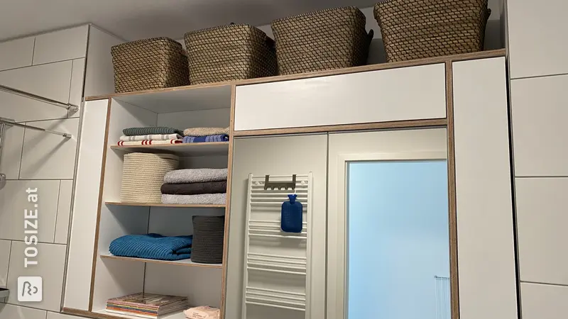 Stylish white bathroom cabinet that also functions as a mirror cabinet, by Zeyna