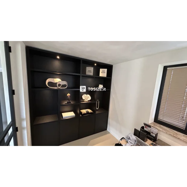 Black cupboard wall with open compartments and doors