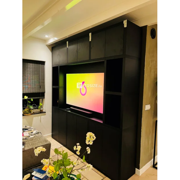 Black cupboard wall with doors and open compartments