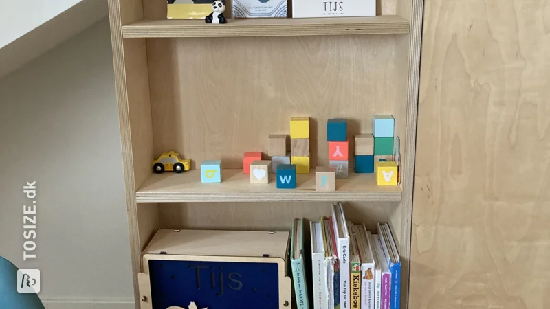 Custom bookcase for chimney pipe made of birch plywood, by Leonoor