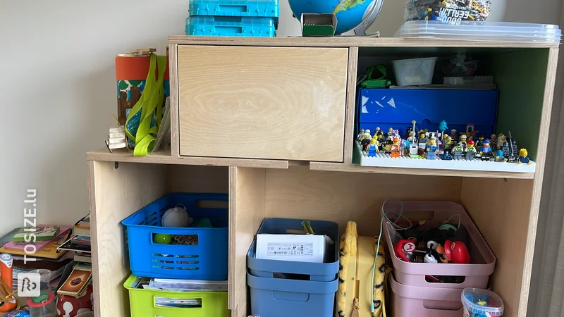 Unique toy cabinet with doors and open compartments made of plywood, by Niels